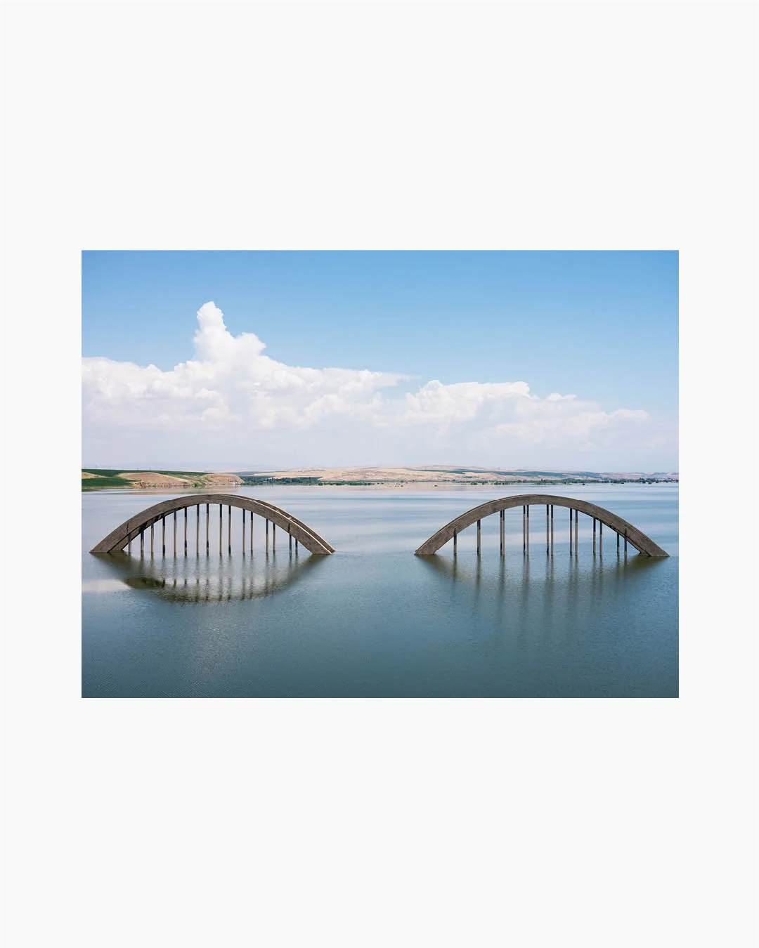 Fine Print: Half of a bridge is still visible in the reservoir lake of the Ilisu Dam, near Batman. Bismil, Turkey, 2010